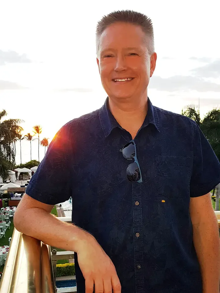 Morten Andersen smiling in front of the sunset in Florida